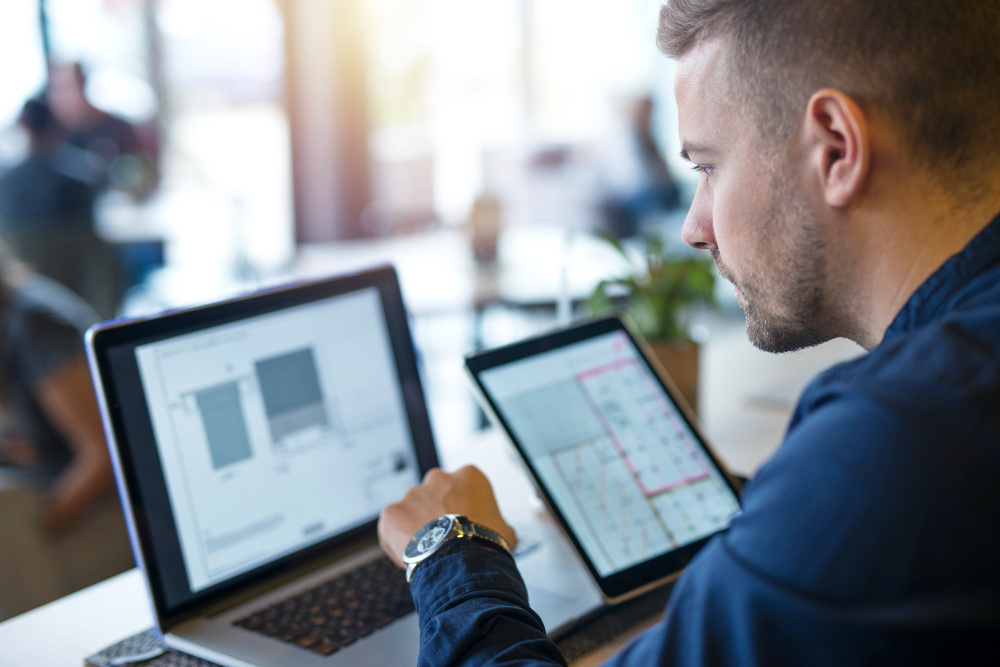 business-man-looking-analyzing-projects-his-laptop-computer-tablet