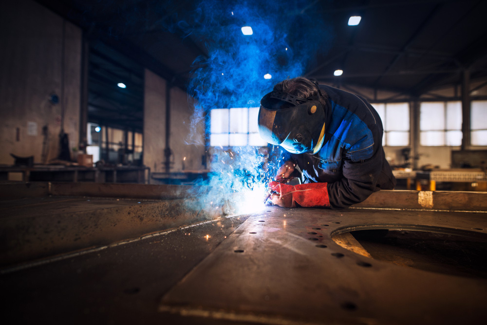 close-up-view-worker-welding-metal-construction-industrial-workshop